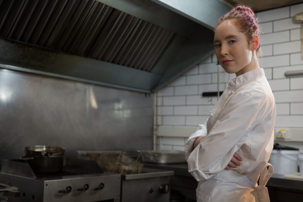 A chef stands in her kitchen at the end of service