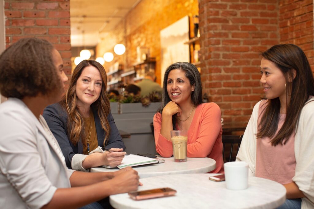 Four female Hospitality professionals in a meeting in their restaurant dining area
